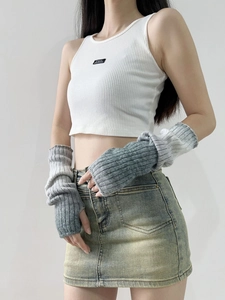 Detail of grey and white gradient knitted arm warmers with a thick wool texture