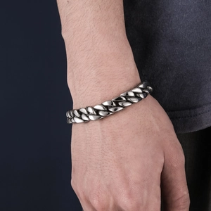 Retro silver alloy Cuban link bracelet for men featuring vintage pattern on hand