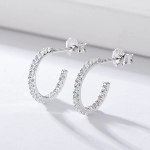 Close-up of S925 sterling silver C-shaped earrings with micro-set clear zircon stones
