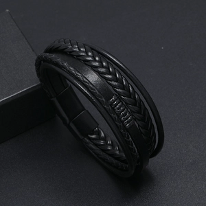 Detail view of multi-layer black leather woven bracelet with metal magnetic clasp