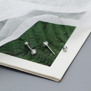Detailed close-up of S925 silver pearl stud earrings with secure screw ball back closure
