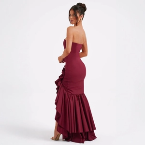 Detail of burgundy off-shoulder dress with layered ruffles and fishtail hemline