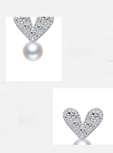 Detailed macro view of S925 sterling silver heart earrings with pearl and cubic zirconia