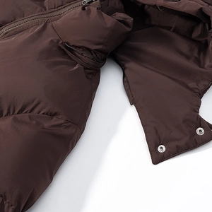 Detailed view of the zipper, metal snap buttons, and quilted texture on the brown jacket
