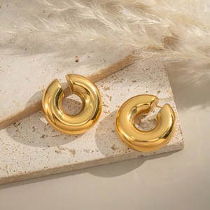 Minimalist 18K gold plated C-shaped chunky ear cuffs on a natural travertine stone base