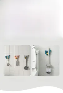 Detail view of multi-color wall-mounted mop holders in kitchen and bathroom settings