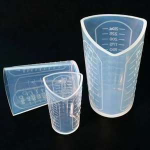 Detail of translucent silicone measuring cups showing scales in ml cups and oz units