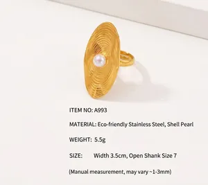 Detailed view of 18K gold plated stainless steel ring with oval shell pearl and wavy texture