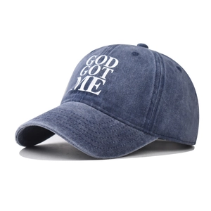 Detail of washed cotton baseball cap featuring God Got Me white printed lettering