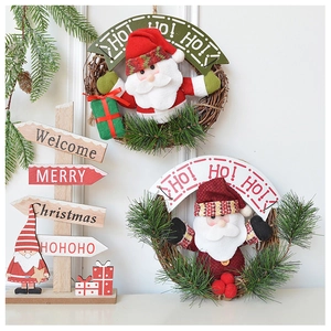 Detail of Christmas Santa wreath and welcome wooden sign with plush fabric texture