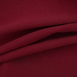 Detailed macro view of dark red lace fabric with elegant crepe texture and grain