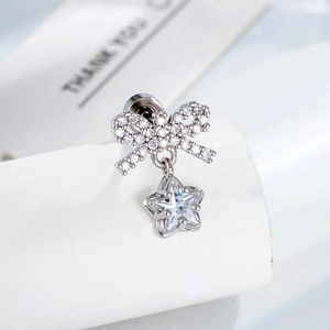Micro-set zircon bow and star silver stud earring shown against a clean white background