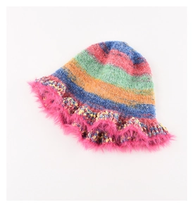 Close-up of rainbow knit bucket hat with pink fuzzy faux fur trim and striped texture