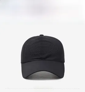 Close-up of black breathable baseball cap showing laser-cut ventilation holes and quick-dry fabric
