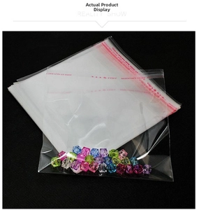 Clear OPP self-adhesive packaging bags showing red seal strip on black background