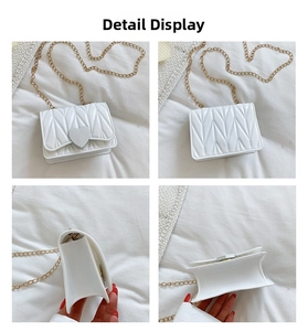 Detail view of white silicone heart bag with V-shaped quilting and golden metal chain