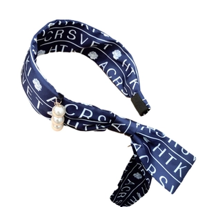 Navy blue satin headband with floral patterns, letter prints and pearl pendant detail