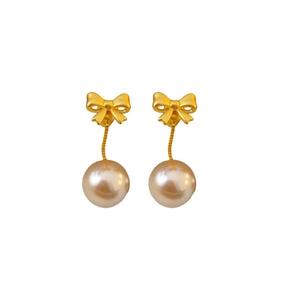 Elegant gold bow earrings with white pearls in a French vintage minimalist style
