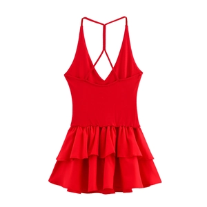 Detailed view of red backless dress featuring layered ruffle skirt and crisscross straps