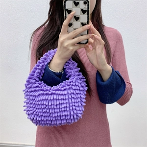 Mirror selfie showing the purple plush chenille handbag texture and hand-held size