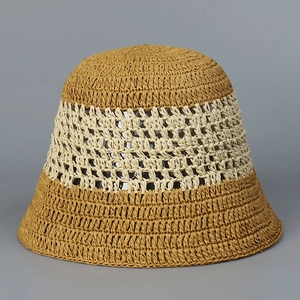 Detailed macro view of two-tone hollow-out crochet pattern on handmade straw bucket hat