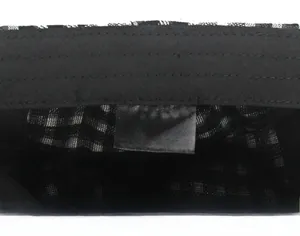 Macro detail of 100% cotton inner lining and black white plaid pattern on flat cap