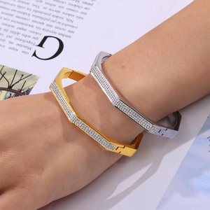 Elegant gold and silver octagonal titanium steel bracelets with pavé zircons worn on wrist