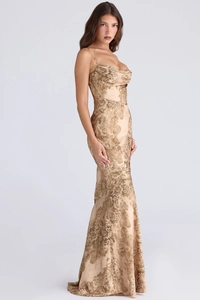 Close-up of golden floral print details and cowl neckline on a long bodycon dress