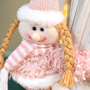 Detail of pink Christmas elf doll showing sequined hat and plush texture on curtain clip