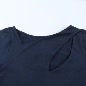 Close-up of navy blue dress featuring asymmetric crossover neckline and cutout detail