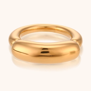 Close-up of a thick polished gold dome ring with a smooth mirror finish for women