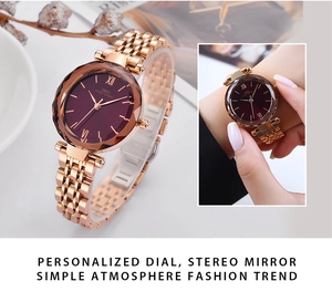 Detail of rose gold mesh strap watch featuring a faceted crystal and deep purple dial