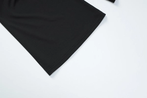 Detailed macro view of the double-needle stitching on the black knitted fabric hem