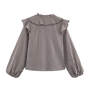 Women's plaid layered long sleeve shirt with ruffle shoulder details on a white background
