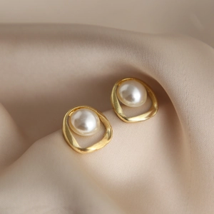 Vintage irregular gold geometric hoop earrings with pearls on champagne silk fabric