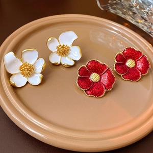 Vintage floral stud earrings set with white and red enamel petals and golden metal details
