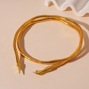 Detailed close-up of flexible gold snake chain necklace with black eye accents
