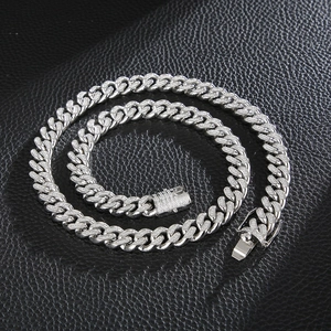 Detail of silver Cuban link necklace with CNC stones and box clasp on leather