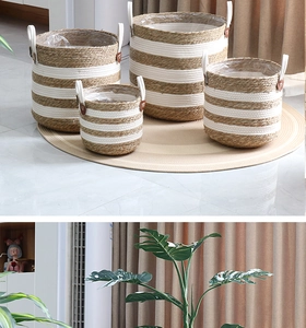 Detail of four-piece natural seagrass woven plant baskets with white cotton rope contrast