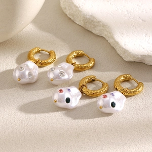 Detailed shot of 18K gold plated Baroque pearl earrings with sparkling colorful rhinestones