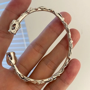 Silver thorn rose open bracelet with intricate vine details and floral rosebuds for women