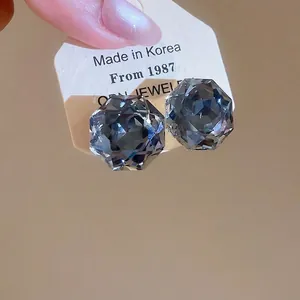 Elegant geometric grey crystal stud earrings with multifaceted cut and silver posts