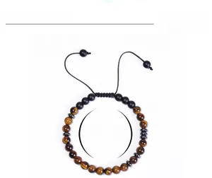 Macro detail of Soul Sister morse code bracelet with tiger eye and matte black beads