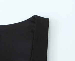 Close-up of neckline and strap detail on a black stretch knit sleeveless tank top
