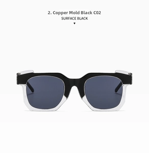 Close-up of irregular black and white geometric sunglasses with grey lenses, model C02