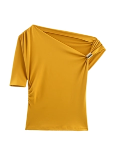 Detail of mustard yellow one-shoulder top featuring pleated fabric and golden metal ring