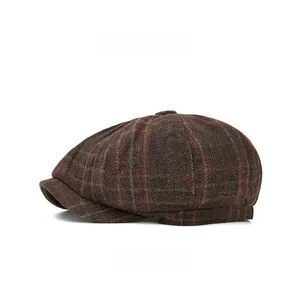 Detailed side view of brown plaid newsboy cap showing textured wool fabric weave
