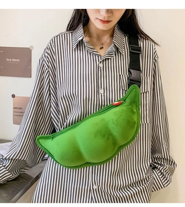 Close-up of green plush pea pod shaped crossbody bag with soft fuzzy texture and strap