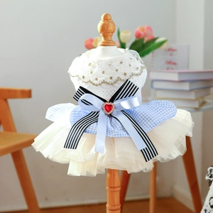 Detail of pet wedding dress with lace bodice, triple layered bow, and red heart gem