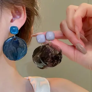 Irregular resin disc drop earrings in navy blue and smoky grey with amber texture